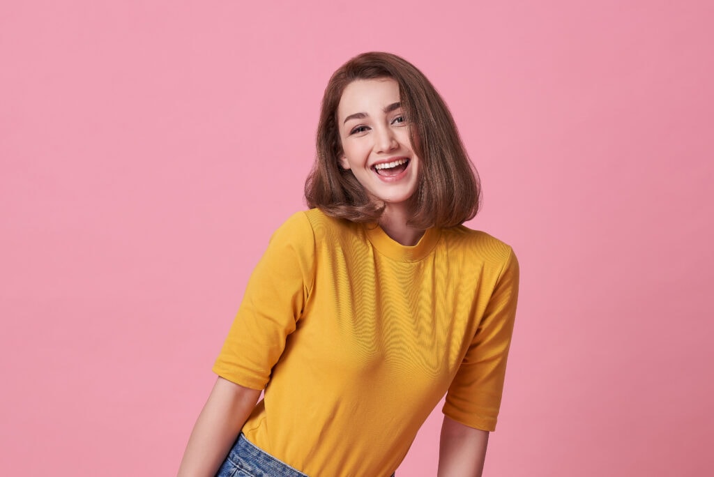 excited beautiful woman with mouth open wearing casual yellow t